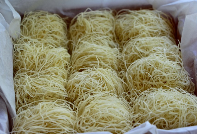 Kadaif nests arranged in a tray close up